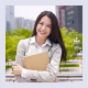 Photo of a smiling woman holding clipboard.