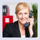 Photo of smiling woman on phone.